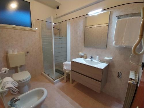 a bathroom with a sink and a toilet and a shower at Hotel Monica in Chianciano Terme