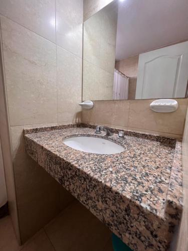 a bathroom counter with a sink and a mirror at Departamentos Hipolito Yrigoyen in San Rafael