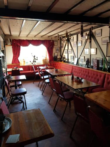 a restaurant with wooden tables and chairs and a window at Prince of Wales inn in Caerphilly