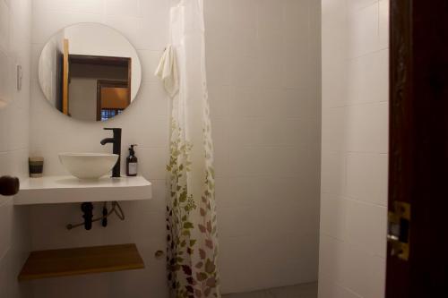 a bathroom with a sink and a mirror at Hostal Magdalena in Santa Marta