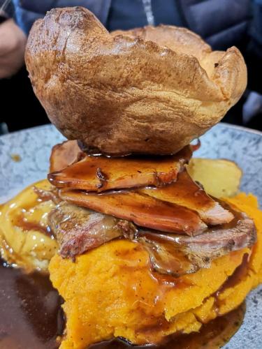 a pile of food on top of a sandwich at The Hinds Head Hotel in Chorley