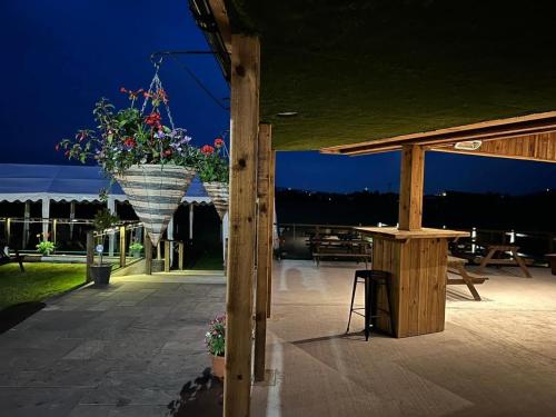 a patio with a table and a pot of flowers at The Hinds Head Hotel in Chorley