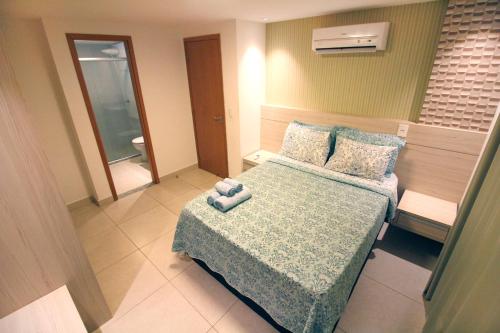 a bedroom with a bed with a teddy bear on it at Luxor Paulo Miranda Home Service in João Pessoa