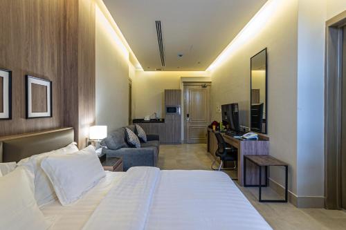 a hotel room with a bed and a living room at Land walk Hotel in Riyadh