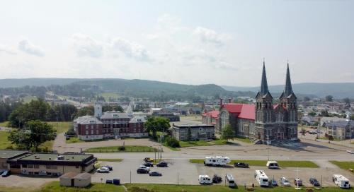 an aerial view of a city with a church at Le Couvent in Sainte-Anne-des-Monts