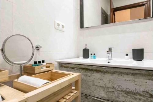 a bathroom with a sink and a mirror at Luxury apartamento Sevilla centro -triana in Seville