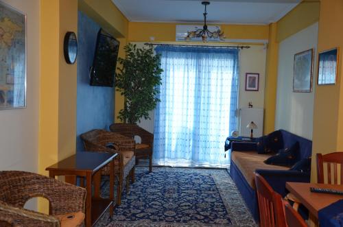 a living room with a couch and a window at Sunray luxury apartment Volos in Volos