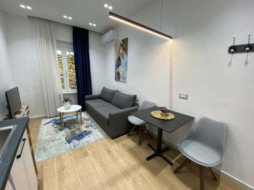 a living room with a couch and a table at Luxury Apartament in Blloku in front of Taiwan in Tirana