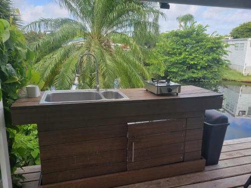 a kitchen sink with a grill on a deck at 1. Great room for rent, Individual entrance, private bathroom, beautiful lake, in manufactured home, 5 min from Hard Rock Hotel Casino in Davie