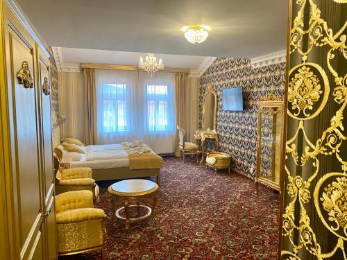 a bedroom with a bed and a table and chairs at Hotel Liliova Prague Old Town in Prague