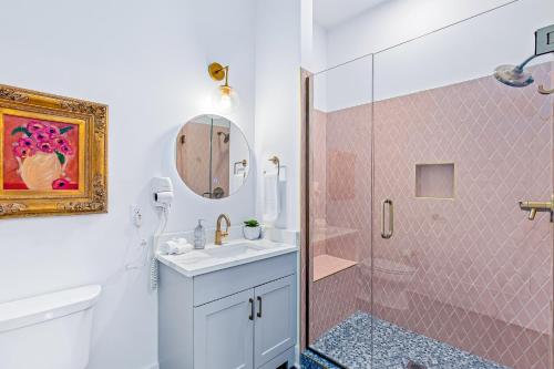 a bathroom with a shower and a sink and a mirror at Jolene on Main 406 in Nashville