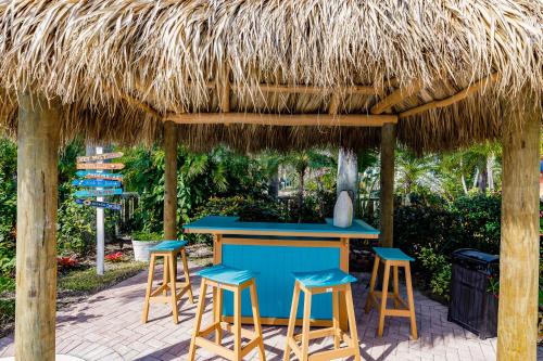 a blue bar with stools under a straw hut at Siesta Key Island Rentals in Siesta Key