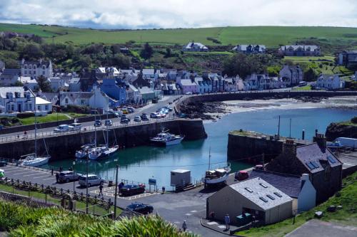 a small town with boats in a harbor at Cedar Lodge in Portpatrick