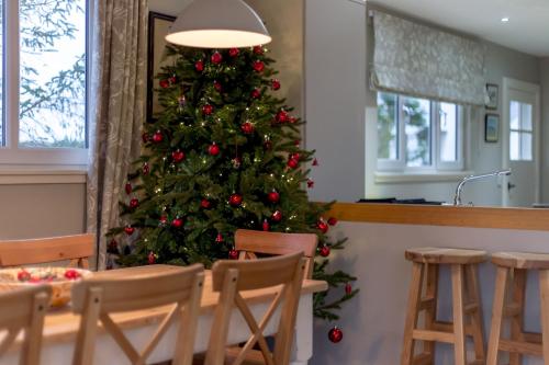 a christmas tree in a kitchen with a table and chairs at Cedar Lodge in Portpatrick