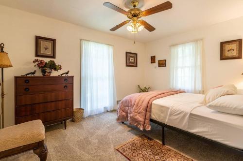 a bedroom with a bed and a ceiling fan at Gail's Gallery in Austell
