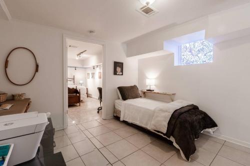 a bedroom with a bed and a sink and a mirror at Gail's Gallery in Austell