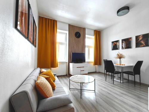 a living room with a couch and a table at Adonis Apartment in Vienna