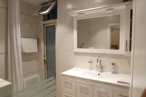 a bathroom with a sink and a shower and a mirror at Kosher Airbnb very close to Central Bus Station in Jerusalem