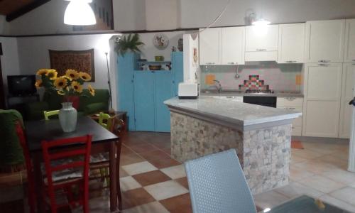a kitchen with a island in the middle of a room at Alle Riserve Vendicari in Casa Maccari