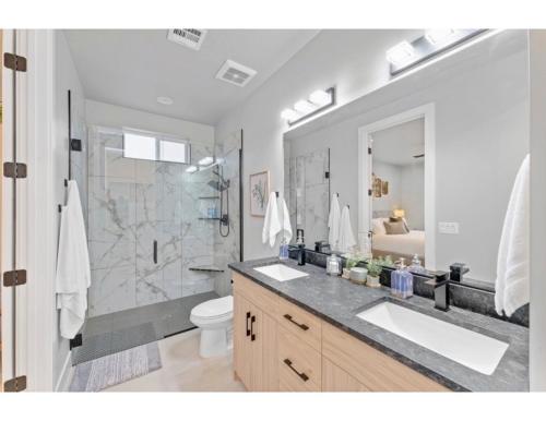 a bathroom with a sink and a shower and a toilet at Desert Hideaway in Hurricane