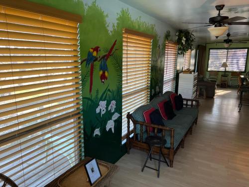 a living room with a bird mural on the wall at Paradise at Canyon Lake in Canyon Lake