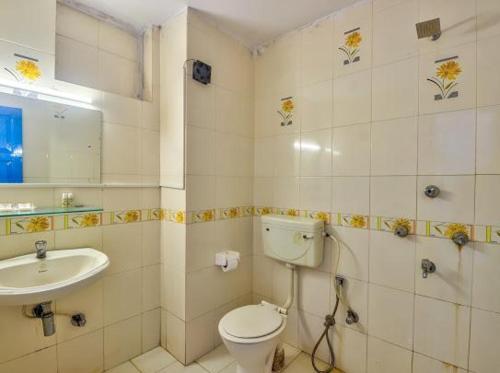 a bathroom with a toilet and a sink at Candolim Boutique House in Candolim