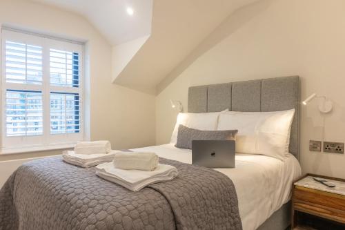 a bedroom with a bed with a laptop on it at Cheltenham Two in Harrogate