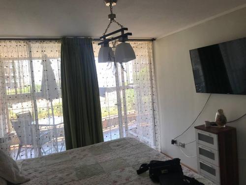 1 dormitorio con cama y ventana grande en Hermoso DEPTO en Viña del Mar en Viña del Mar