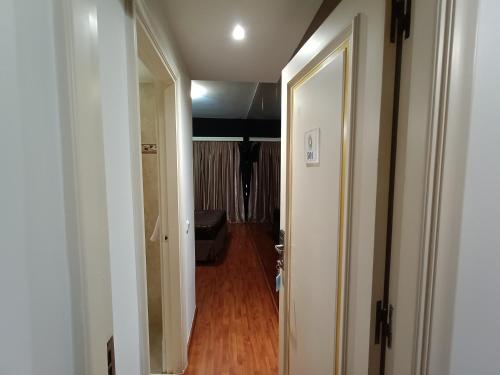 a hallway with a door leading to a room at Queens Leriotis Hotel in Piraeus