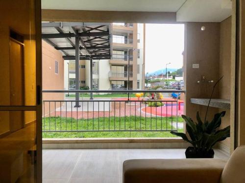 a living room with a view of a park through a window at Apartamento para turismo Villeta - para 7 personas in Villeta