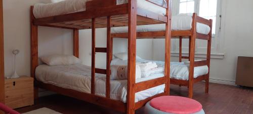 two bunk beds in a room with a bed at Hostel La Cumbre Tandil in Tandil
