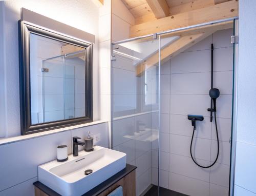 a bathroom with a sink and a shower at Chuenislodge3 neu&stilvoll, 2Balkone, echtes Bijou mit top-Aussicht in Adelboden
