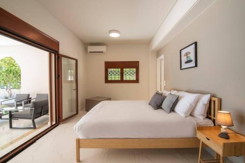 a bedroom with a large bed and a patio at villa lion in Agioi Theodoroi