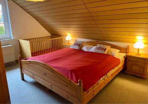 um quarto com uma grande cama de madeira e 2 mesas de cabeceira em Venti Maris em Kellenhusen