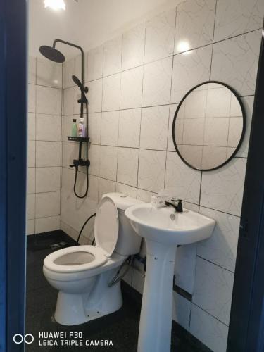 a bathroom with a toilet and a sink at Hounon White Chimney Cottage-4 Bedrooms in Ranau