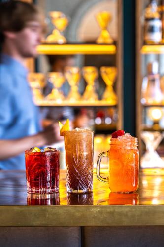 a group of three cocktails sitting on a bar at Fowey Hall Hotel in Fowey