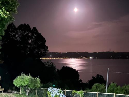 a moonlit view of a body of water at night at CIPRES Ecolodge & Spa in Frutillar