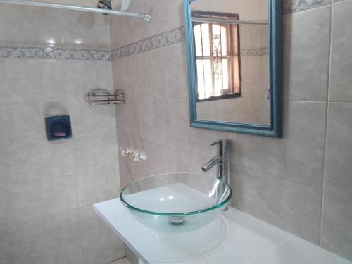 a bathroom with a glass bowl on a sink at Bed and breaksfast in Punta del Este