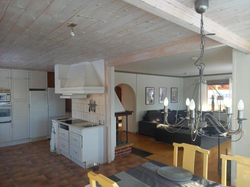 a kitchen and living room with a table and chairs at Lägenhet centrala Sollerön in Sollerön