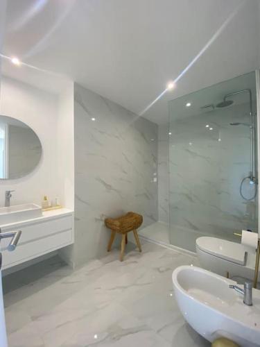 a white bathroom with two sinks and a shower at Moradia - Vila Golfe Amarante in Amarante