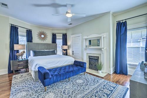 een slaapkamer met een bed en een blauwe bank bij Immaculate Birmingham House with Covered Porch! in Birmingham