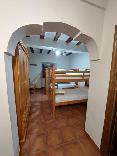 a room with a room with beds and a hallway at ALBERGUE CASA LAS ANGELITAS in Quel