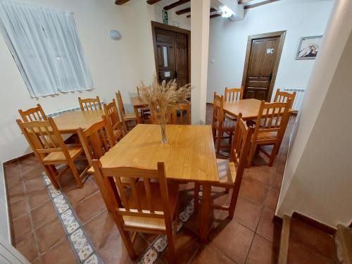 a dining room with wooden tables and chairs at ALBERGUE CASA LAS ANGELITAS in Quel