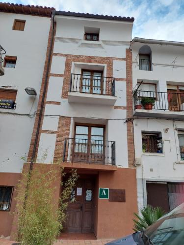 an apartment building with two balconies and a door at ALBERGUE CASA LAS ANGELITAS in Quel