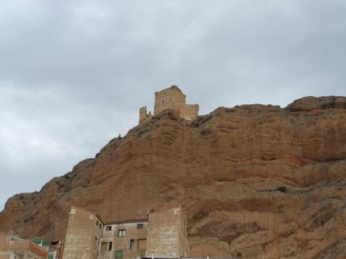 a castle on the side of a mountain at ALBERGUE CASA LAS ANGELITAS in Quel