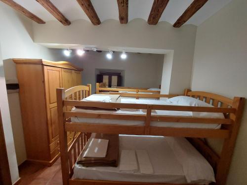 a bedroom with two bunk beds and a mirror at ALBERGUE CASA LAS ANGELITAS in Quel
