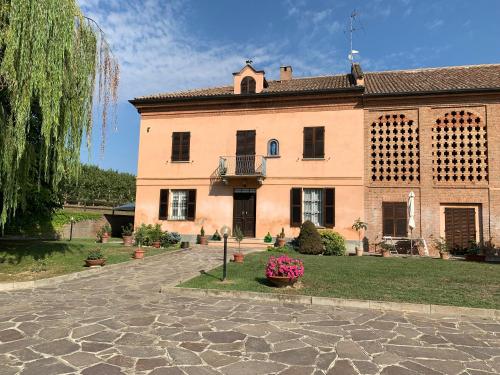 a large house with a stone driveway in front of it at Casa villetta "La Colomba" Nizza Monferrato in Nizza Monferrato