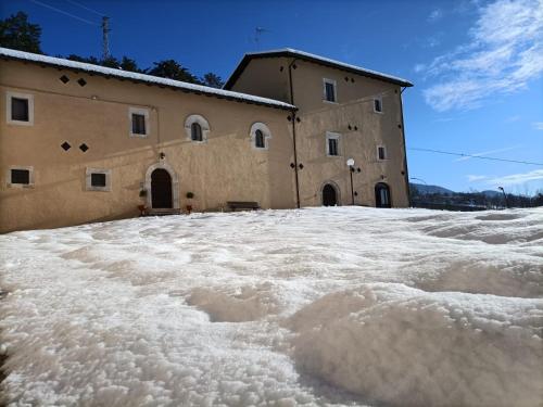 a building with a lot of snow in front of it at Casa Fra Ambrogio in Pizzoli