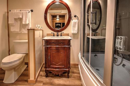 a bathroom with a sink and a toilet and a mirror at Yellowstone Gateway Inn in Gardiner