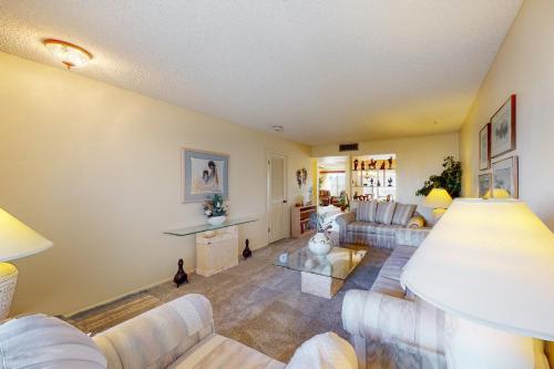 a living room with couches and a table at Sun in the City in Sun City